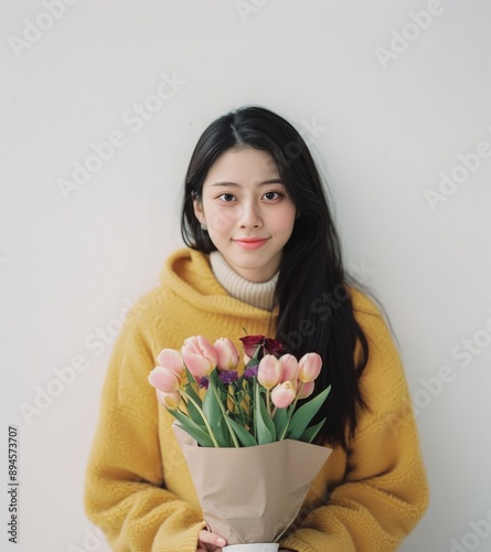Woman in Yellow Coat Holding Tulips