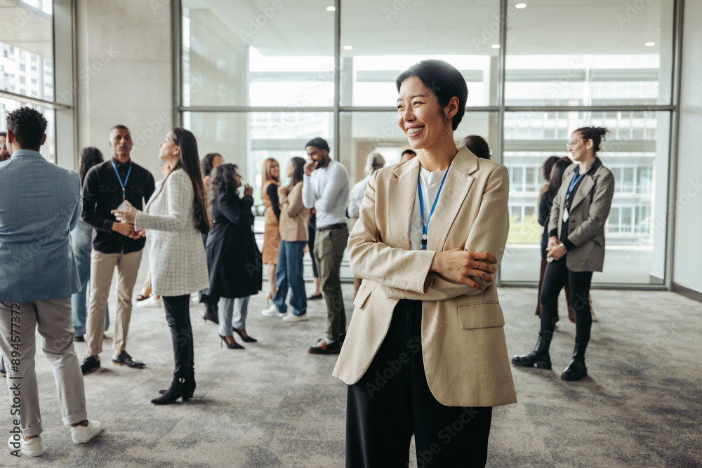 Successful businesswoman leader smiling in modern office setting with colleagues during a networking day Successful businesswoman leader smiling in modern office setting with colleagues during a networking day