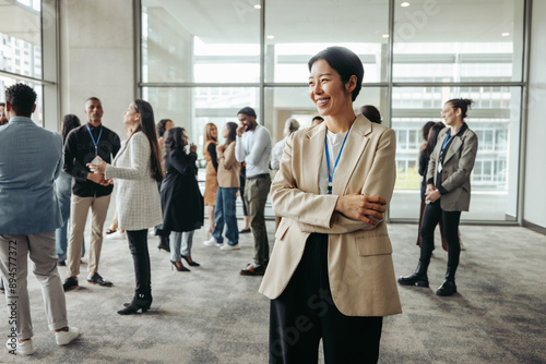 Successful businesswoman leader smiling in modern office setting with colleagues during a networking day