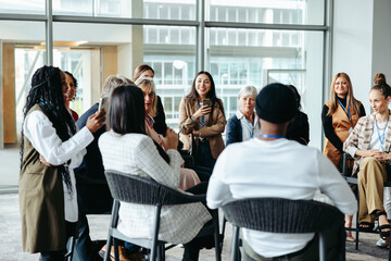 Dynamic exchange: Professionals in seminar discussion at modern office
