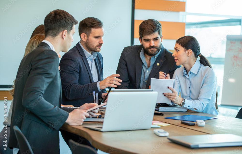 Group of coworkers interacting during a business meeting in the office Group of coworkers interacting during a business meeting in the office