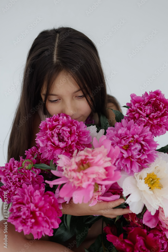 A girl with a beautiful bouquet of peons A girl with a beautiful bouquet of peons