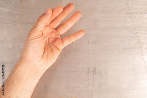 A hand is extended outward ...