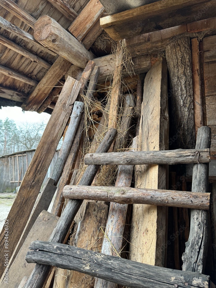 a wooden ladder near a village barn a wooden ladder near a village barn