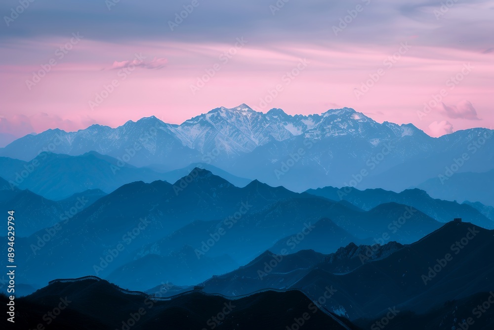 Fototapeta premium The Great Wall of China, the silhouette of snow-capped mountains in pink and blue tones at dusk, high definition photography 