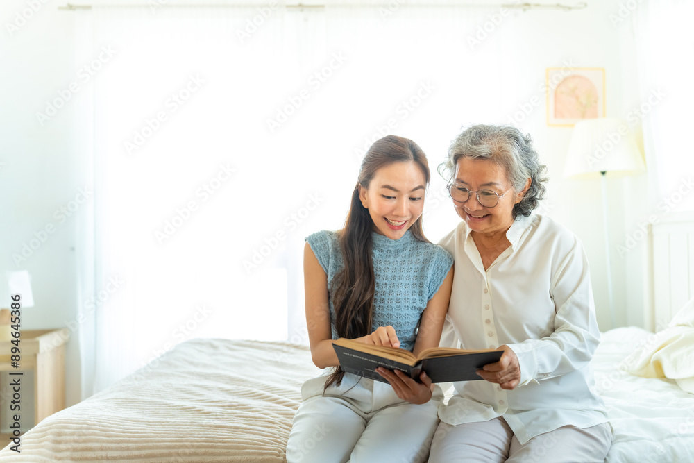 © CandyRetriever - Happy Asian senior mature woman reading a book with caregiver in bedroom. Happy elderly woman enjoy indoor activity lifestyle at home. Senior people mental health care, nursing and caregiving concept. © CandyRetriever - Happy Asian senior mature woman reading a book with caregiver in bedroom. Happy elderly woman enjoy indoor activity lifestyle at home. Senior people mental health care, nursing and caregiving concept.