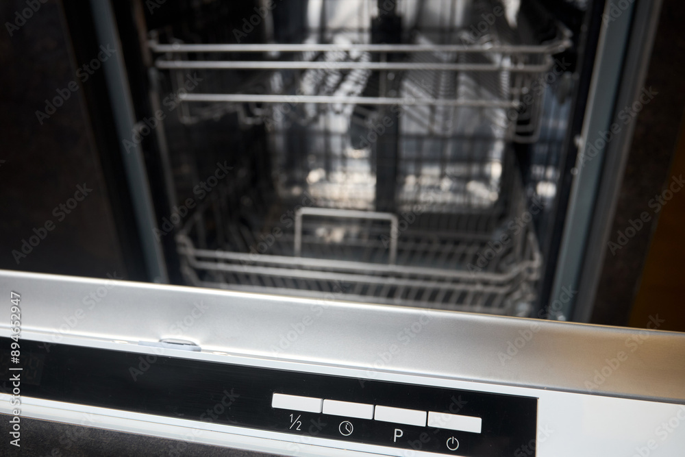 Dishwasher control panel closeup. Mode program timer knobs on control panel of dishwasher machine selected focus over out of focus background. Dishwasher control panel closeup. Mode program timer knobs on control panel of dishwasher machine selected focus over out of focus background.