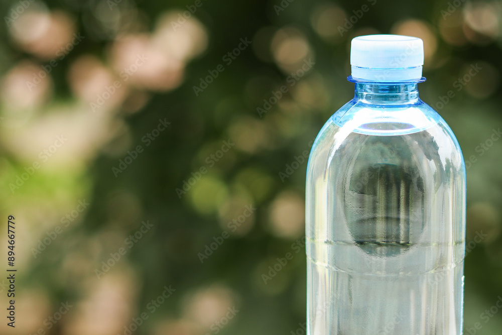 bottle of mineral water on a green background bottle of mineral water on a green background