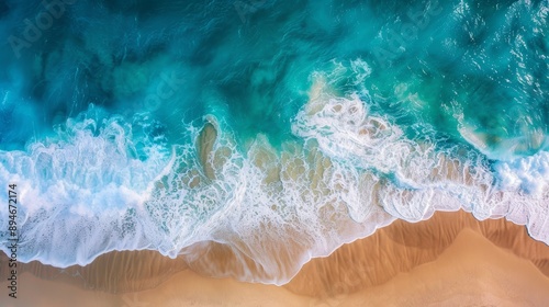 Create an aerial view of a sandy beach and the ocean with waves. Highlight the textures of the sand, the patterns of the waves, and the contrast between the beach and the ocean. Showcase the natural b photo