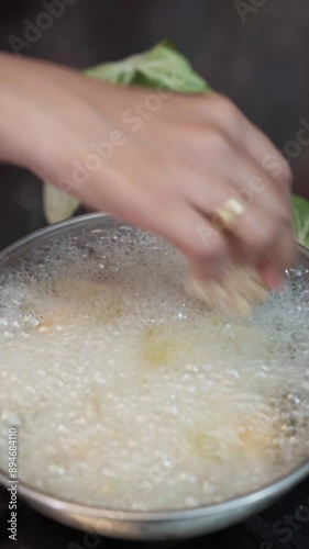 Frying batti or bati in a frying pan. rajasthan famous food bati or batti frying. batti or bati making,  photo