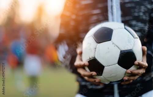 Soccer Ball in Goal Net at Sunset