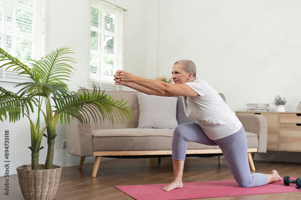 Obraz premium Elderly Woman Practicing Relaxing Yoga at Home in Bright Living Room for Health and Wellness