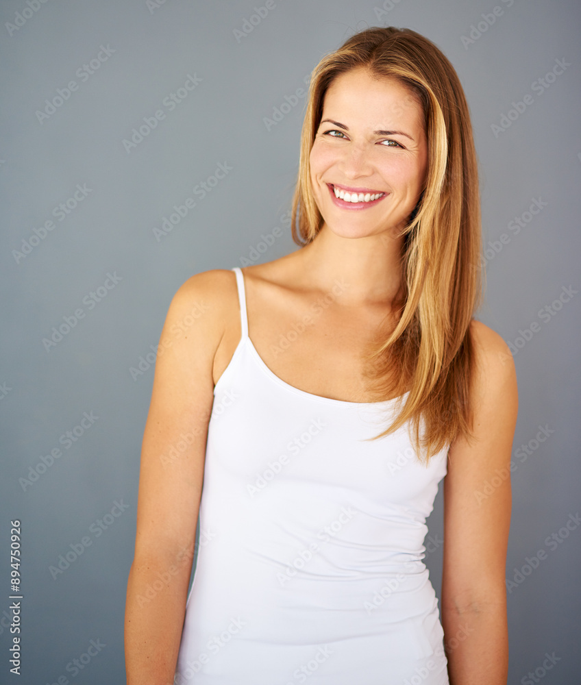 Woman, portrait and smile with hair, beauty and hairstyle for cosmetic care and glow. Natural, confidence and keratin treatment for salon, shine and aesthetic isolated on gray studio background Woman, portrait and smile with hair, beauty and hairstyle for cosmetic care and glow. Natural, confidence and keratin treatment for salon, shine and aesthetic isolated on gray studio background