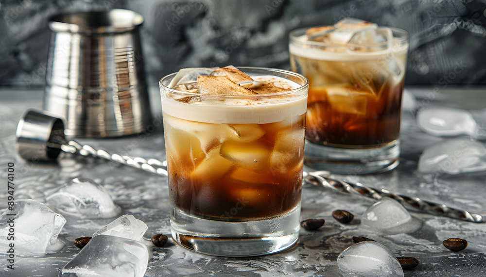 White russian cocktail, trendy alcoholic drink with vodka, coffee liqueur, cream and ice, gray background, bar tools White russian cocktail, trendy alcoholic drink with vodka, coffee liqueur, cream and ice, gray background, bar tools