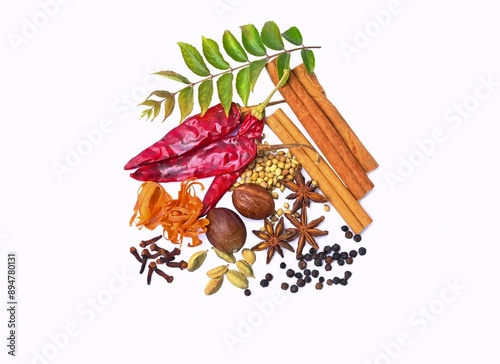 Whole spice mix, isolated on white background. Indian traditional garam masala powder ingredients photo