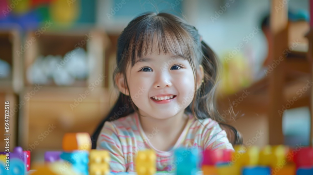 Happy child playing with colorful toys Happy child playing with colorful toys