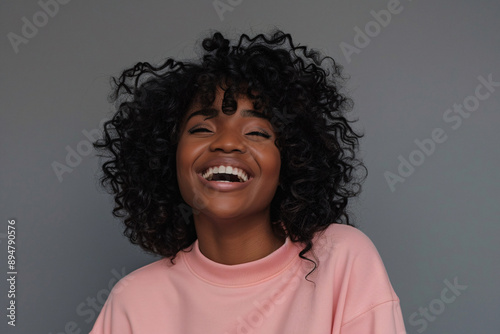 a woman with curly hair laughing