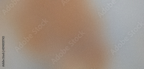 Grainy textured surface creating a gradient from brown to gray in abstract background