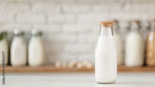 A fresh glass bottle of milk stands on a clean surface, showcasing natural ingredients and a rustic wooden cap.