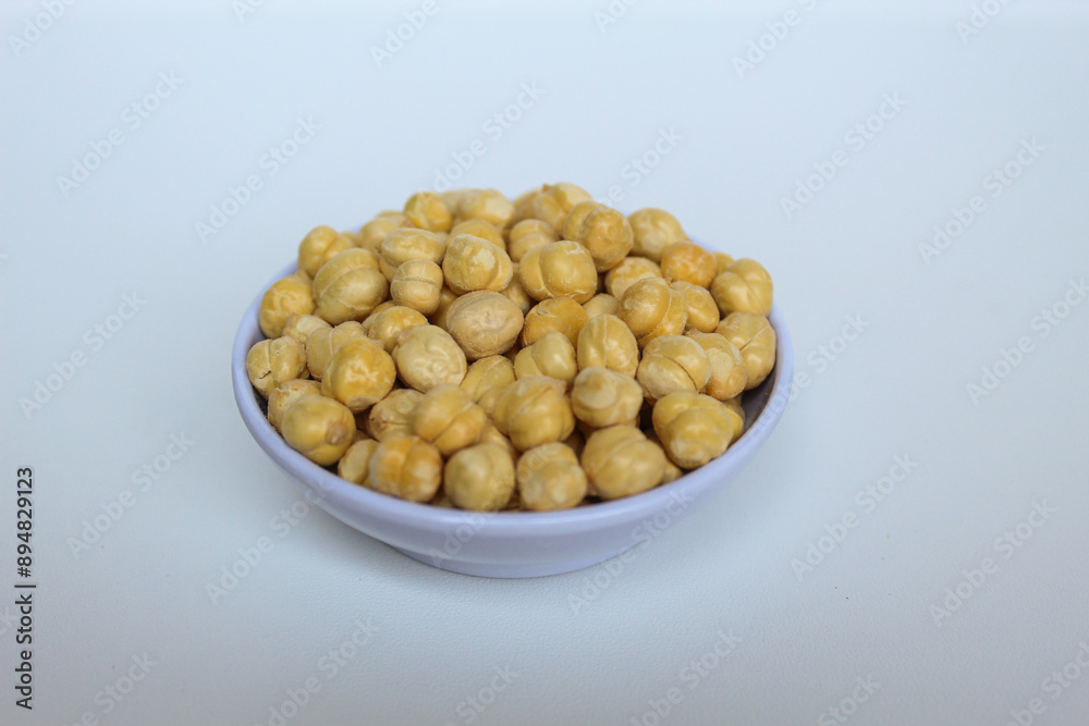 Chickpeas in small white bowl, isolated on white background Chickpeas in small white bowl, isolated on white background