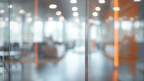 Blurred empty open plan office with chair and table with modern window with bokeh lights in the background, office interior for design