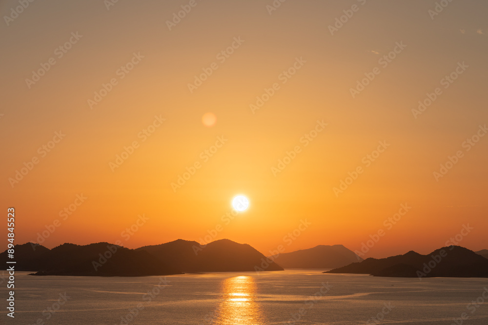 Orange sunset sun over the islands in the Mediterranean Sea Orange sunset sun over the islands in the Mediterranean Sea