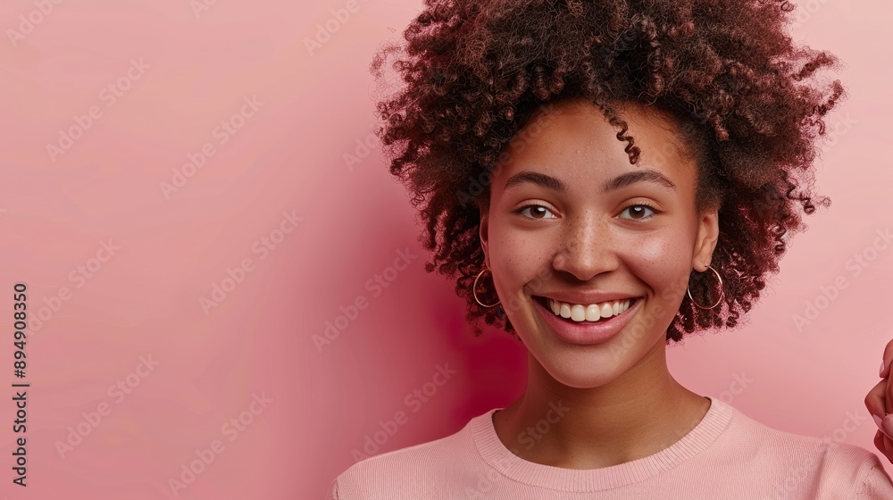 a smiling woman with curly hair, dressed casually and talking to a friend, against a soft pink background, suitable for showcasing text or promotional content. a smiling woman with curly hair, dressed casually and talking to a friend, against a soft pink background, suitable for showcasing text or promotional content.
