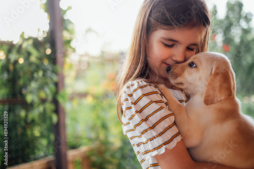 Cuadro en lienzo Close-up portrait of a little girl hugging a puppy