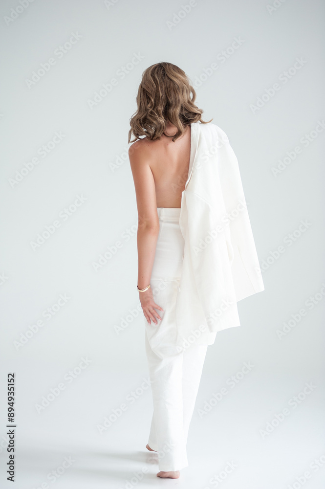 Elegant woman in white suit on white background Elegant woman in white suit on white background