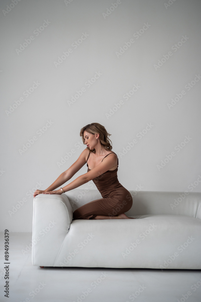 young beautiful woman in beige dress on white background posing in studio young beautiful woman in beige dress on white background posing in studio