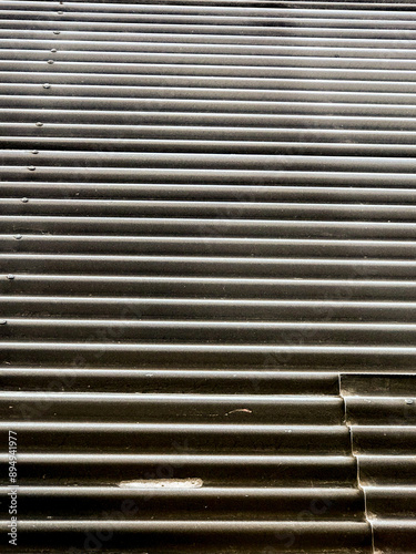 background of a black corrugated sheet metal roof.