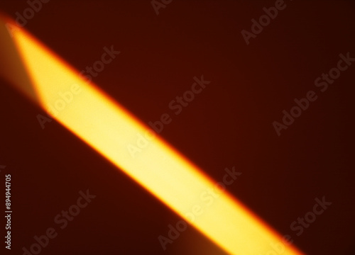 Diagonal light beam falling on room wall backdrop photo