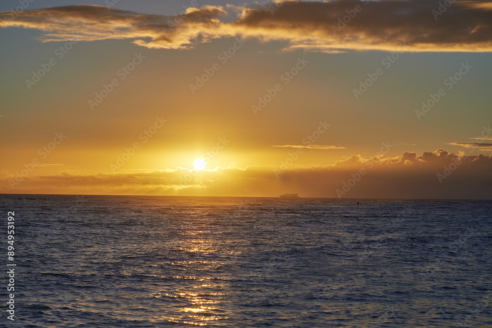 Sunset, sea and horizon of natural environment, beach and ocean during night in summer. Sky, nature and sunrise in landscape for tropical, calm and destination with island peace on Waikiki, Honolulu Sunset, sea and horizon of natural environment, beach and ocean during night in summer. Sky, nature and sunrise in landscape for tropical, calm and destination with island peace on Waikiki, Honolulu