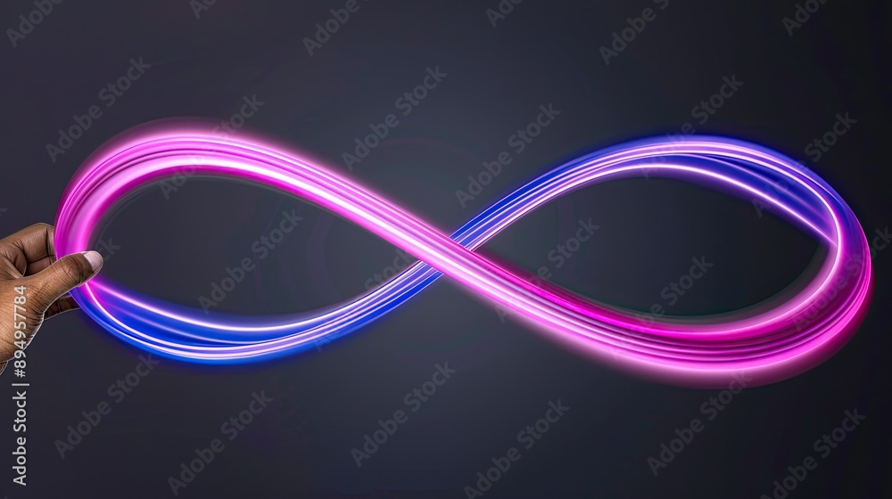 Hand Creating a Blue and Pink Infinity Symbol With Light Painting Hand Creating a Blue and Pink Infinity Symbol With Light Painting