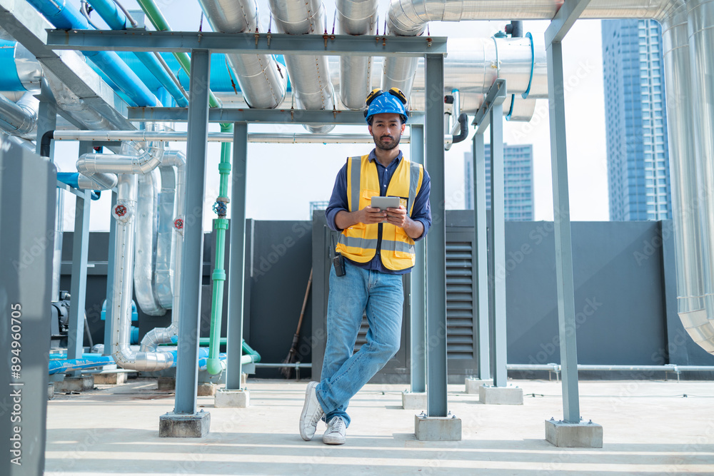 Engineer Inspecting Industrial Pipes on Rooftop Engineer Inspecting Industrial Pipes on Rooftop