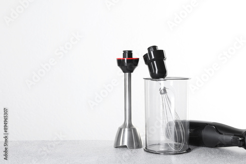Schilderij op canvas Hand blender kit on gray table against white background, space for text