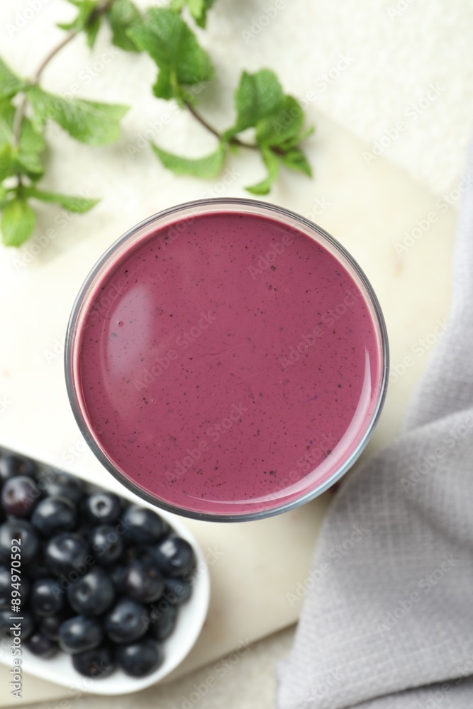 Tasty fresh acai juice in glass on light table, top view Tasty fresh acai juice in glass on light table, top view