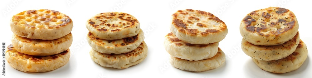Freshly baked crumpets stacked artfully, showcasing their golden brown texture and unique shape, perfect for breakfast dishes. Freshly baked crumpets stacked artfully, showcasing their golden brown texture and unique shape, perfect for breakfast dishes.