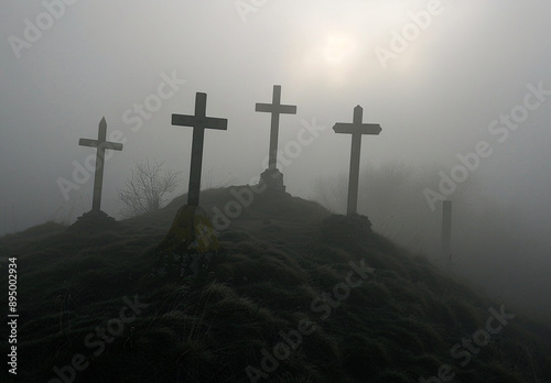 Misty hilltop with four crosses silhouetted against the fog, creating a spiritual and serene scene. Suitable for religious and nature-themed content.