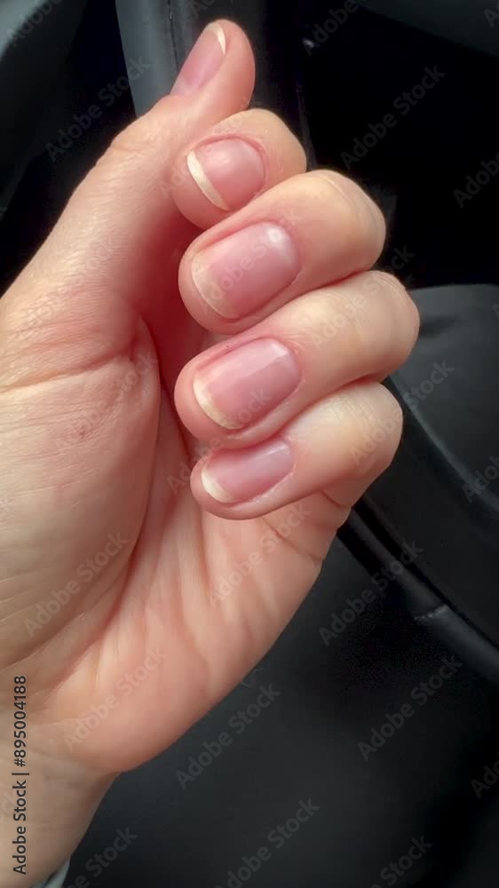 Woman manicured hands with nude nails Woman manicured hands with nude nails