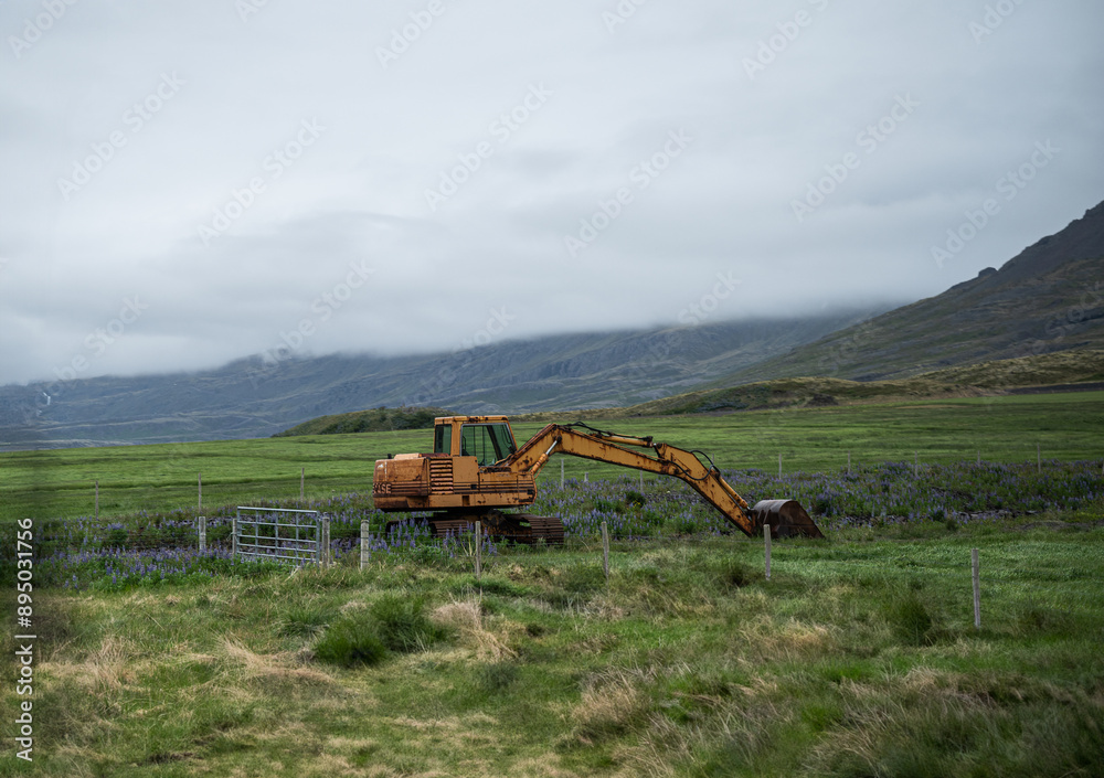 Fototapeta premium yellow excavator in a field in Iceland
