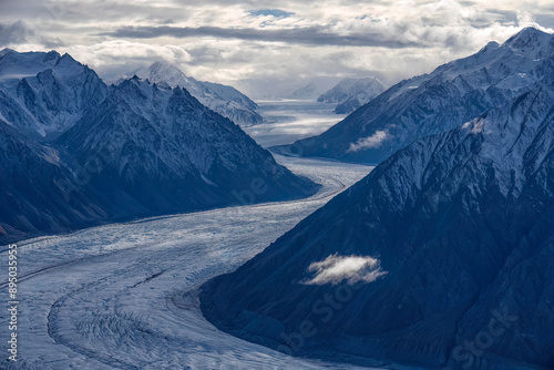 Aerial views of the Donjek Glacier winding through the mountains of Kluane National Park, Yukon, taken during the transition between autumn and winter; Haines Junction, Yukon, Canada photo