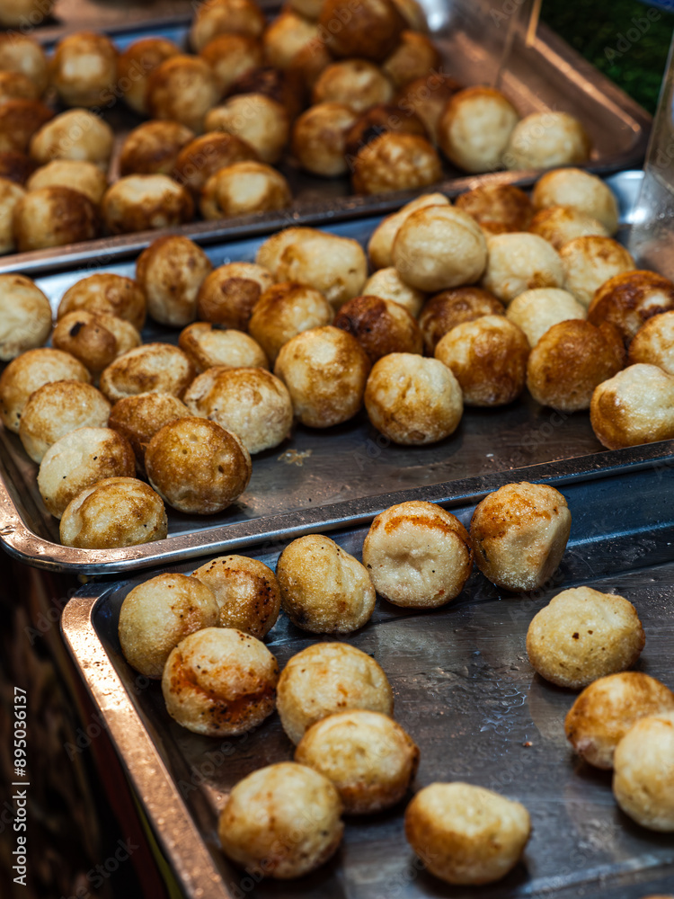Close-up of trays filled with golden brown fried food balls Close-up of trays filled with golden brown fried food balls