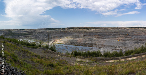 Stone quarry. Opencast mining quarry with lots of machinery at work - view from above