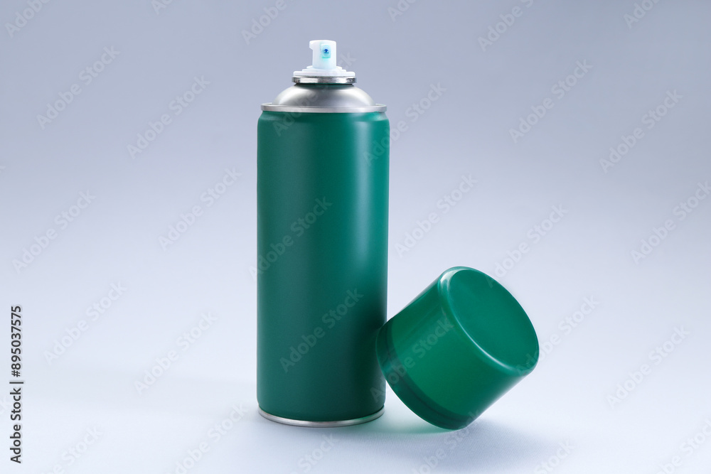 Green spray paint can on gray background Green spray paint can on gray background