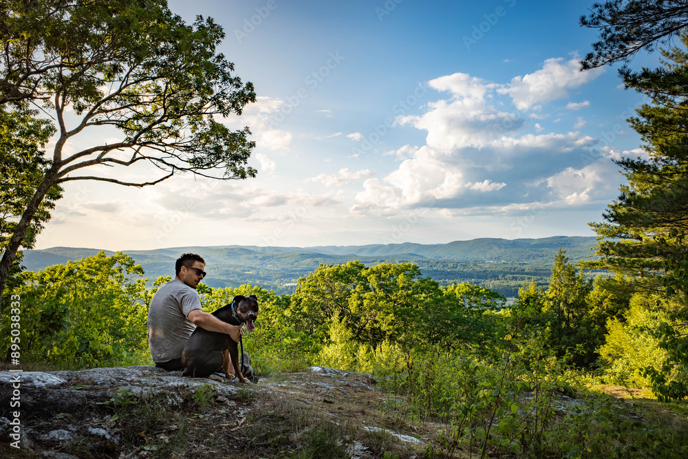 Man and his dog at a scenic viewpoint overlooking Keene New Hamp Man and his dog at a scenic viewpoint overlooking Keene New Hamp