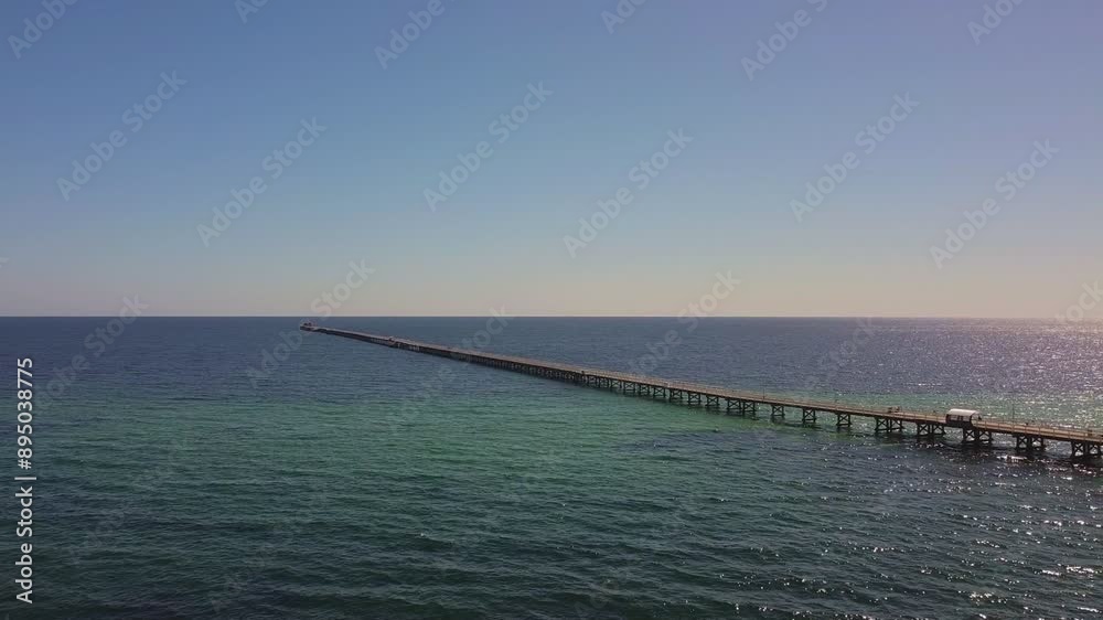 Busselton Jetty - Aerial view high alongside longest timber piled jetty in the southern hemisphere Busselton Jetty - Aerial view high alongside longest timber piled jetty in the southern hemisphere