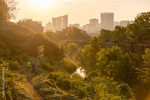 Two friends trail running with a skyline in the background. photo