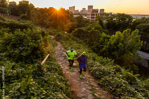 Two friends trail running with a skyline in the background. photo