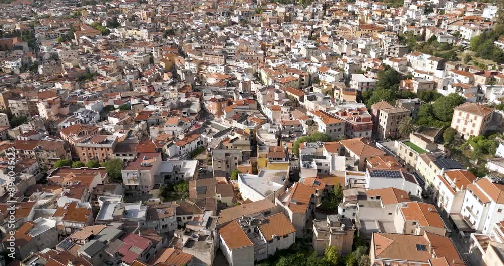 Crowded Mountain Village Of Dorgali On Sunny Day In Sardinia, Italy. aerial pullback, tilt-up shot Crowded Mountain Village Of Dorgali On Sunny Day In Sardinia, Italy. aerial pullback, tilt-up shot